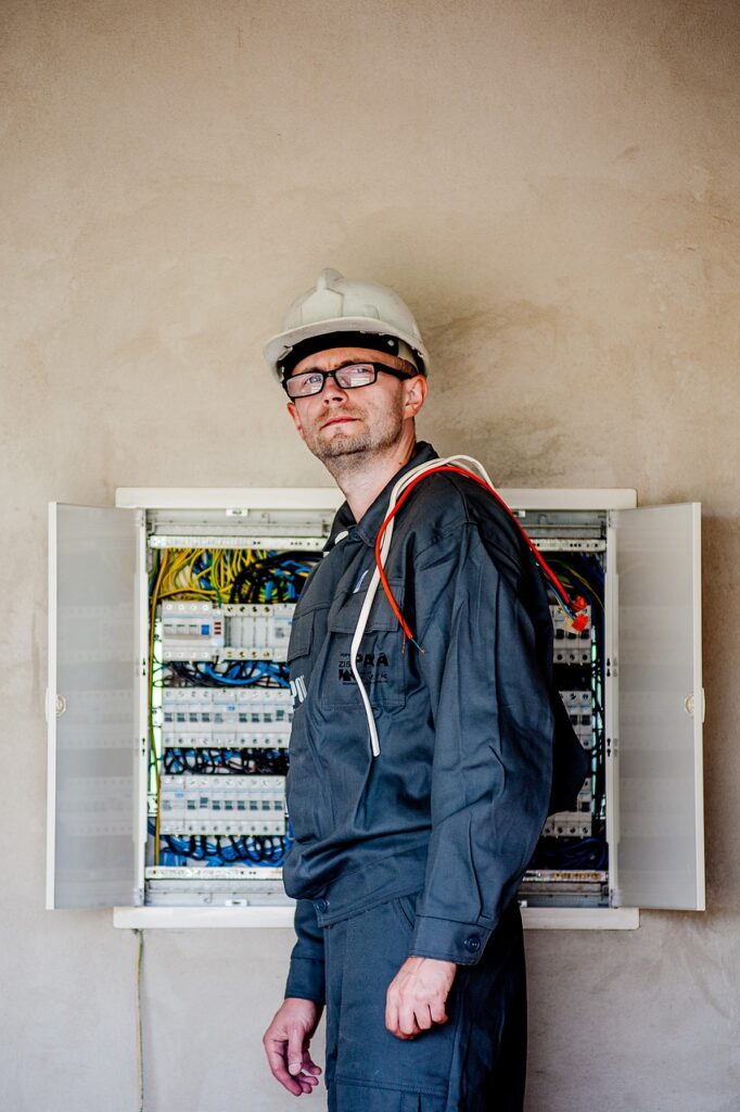 Certified electrician smiling and looking directly at the camera, ready to install or repair EV charging stations in Northern New Jersey.