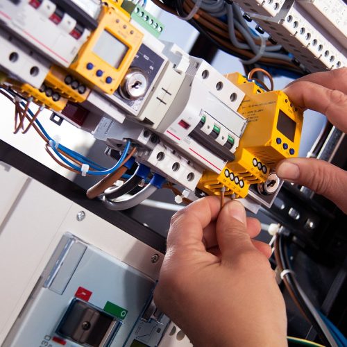 Certified technician working on electrical wiring for an EV charging station installation in Hudson County, New Jersey.